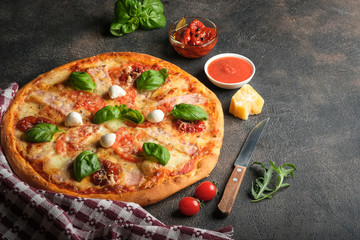 Traditional Italian pizza on a dark background copy space top view. 