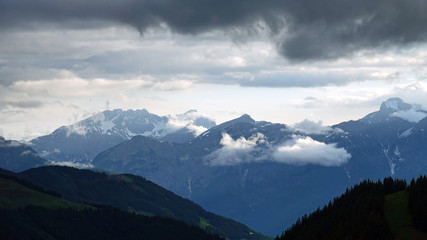 in the mountains with view to the alps on a foggy morning with sunlight