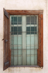 Old latticed window in wall, vertical picture