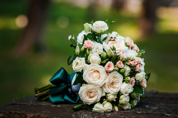 Gold wedding rings on the pink bouquet of flowers