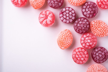 Candy canes sweets in form of juicy berries on white background isolated top view