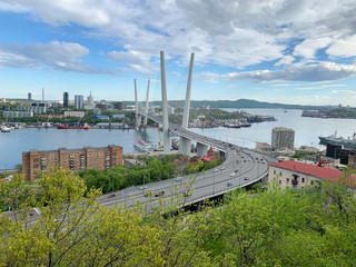 Fototapeta premium Cable-stayed bridge over Zolotoy Rog (Golden horn) Bay and Churkin Cape in Vladivostok in evening spring, Russia