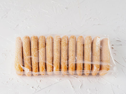 Ladyfinger Savoiardi Biscuit Cookie In Plastic Package On White Concrete Background