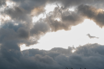 Naklejka na ściany i meble Storm clouds rolling in during sunrise