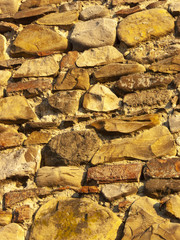 Typical detail of an ancient Italian house wall, made of hand-carved river stones.