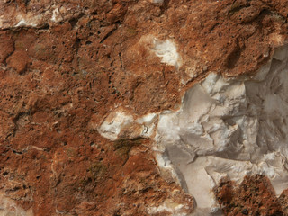Typical detail of an ancient wall of an Italian house in Rimini, on the Adriatic coast, made of hand-carved stones.