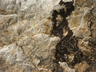 Typical detail of an ancient wall of an Italian house in Rimini, on the Adriatic coast, made of hand-carved stones.
