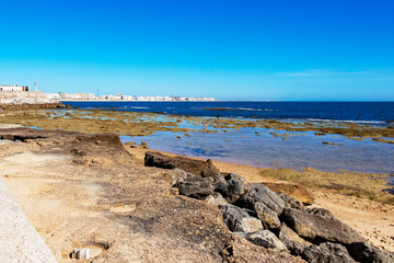 View of Cadiz and coastline, Province of Cadiz, Andalusia, Spain from the causeway to the Castle of San Sebastian