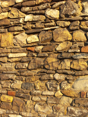 Typical detail of an ancient Italian house wall, made of hand-carved river stones.
