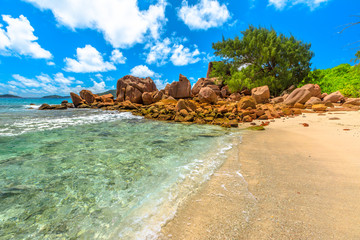 Turquoise waters of Anse Caiman, La Digue, Seychelles, reached with a trek in the forest and is far...