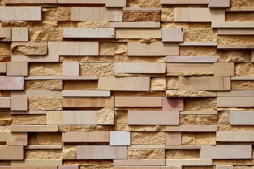 Close up abstract pattern of sandstone brick wall background in vintage tone style, exterior architecture concept