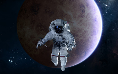 Obraz na płótnie Canvas Astronaut on background of Venus. Solar system. Science fiction. Elements of this image furnished by NASA