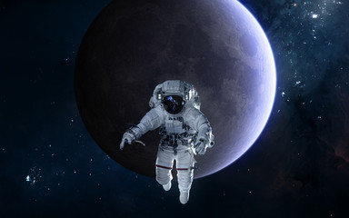 Astronaut on background of the Moon. Solar system. Science fiction. Elements of this image...
