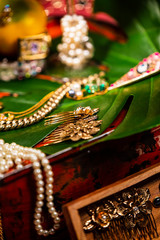 Jewellery arranged on a Palm Leave and Metal Box