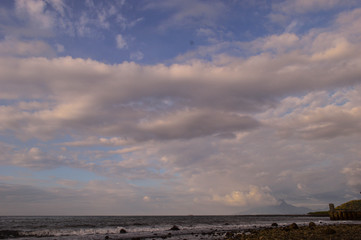 afternoon sky landscape with silhouettes of rocky beaches and trees
