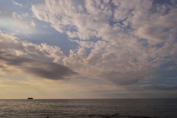 afternoon sky landscape with silhouettes of rocky beaches and trees