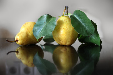 Two ripe yellow pears lying on the table