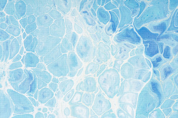 Beautiful background of liquid acrylic in blue and white on canvas