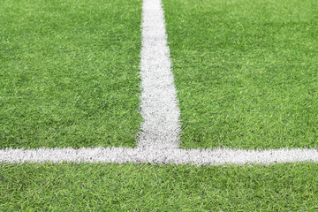 Obraz premium Marking white paint on a green grass of the football field.