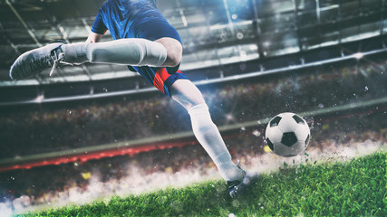 Football scene at night match with player kicking the ball with power