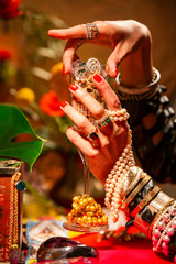 Cropped Hand holding Champagne Flute filled with Jewellery