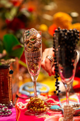 Champagne Flutes filled with Jewellery with Flowers in the Background