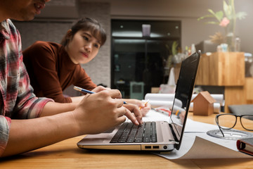 Group of two coworkers working with blueprint in office. co-working teamwork concept.