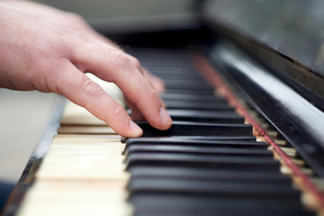 Fototapeta premium Closeup shot of male hands on the piano keyboard.
