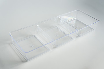 Acrylic clear plastic organizer with 3 compartments on a white background.