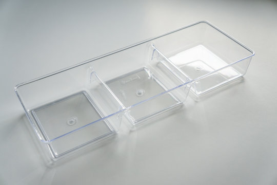 Acrylic clear plastic organizer with 3 compartments on a white background.