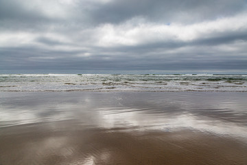 Cloud reflections in the sand, at Cannon Beach on the Oregon coast