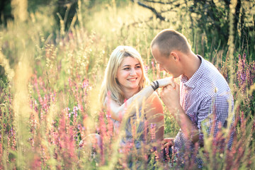 Young couple in the summer on the nature. The concept of relationships, love and relaxation.