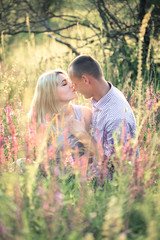 Young couple in the summer on the nature. The concept of relationships, love and relaxation.