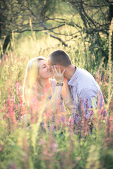 Young couple in the summer on the nature. The concept of relationships, love and relaxation.