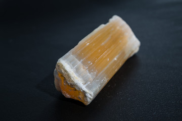 Ural selenite mineral, moonstone, raw very beautiful close-up on a black background