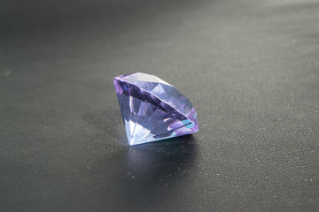 Amethyst with a cut for jewelry close-up on a black background