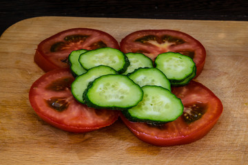 Chopped Tomato and Cucumber Rings on a Cutting Board for Healthy Food and Vegetarian Close-Up Food