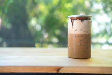 Iced mocha in clear plastic tin.