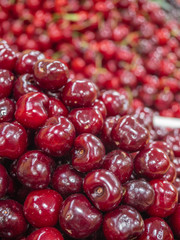 bunch of ripe red cherries on fruit rack