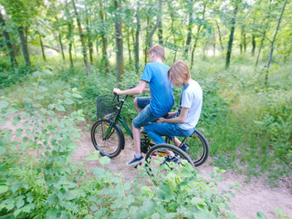 Obraz premium Two guys ride a tricycle