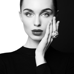 beautiful young woman with big ring pose in studio