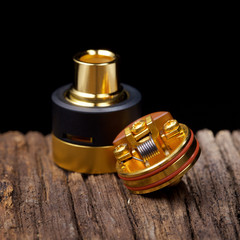 close up, macro shot of high end rebuildable dripping atomizer for flavour chaser on natural wood...