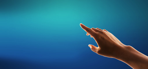 Hand pressing a button on a blue background