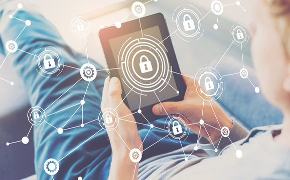 Cyber security theme with man using a tablet in a chair