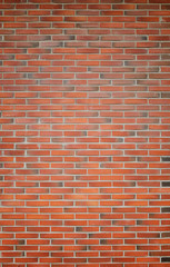 High resolution full frame background of detailed new red brick wall with vignetting.