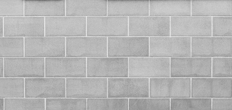 High resolution full frame background of a new, modern and clean wall or building exterior made of stone slabs in black and white.