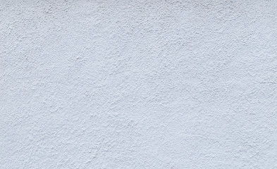 High resolution full frame background of a rough plastered concrete wall in light blue or white color.