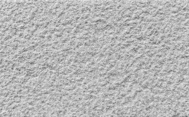 Close-up of a bumpy granite stone wall in black and white. High resolution full frame background texture.