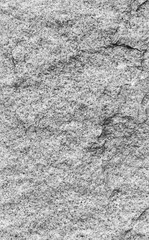 Close-up of white, fine-grained granite surface in black and white. High resolution full frame texture background.