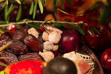 Obraz na płótnie Canvas Close Up of Table decorated with Autumn and Winter Fruits and Edibles